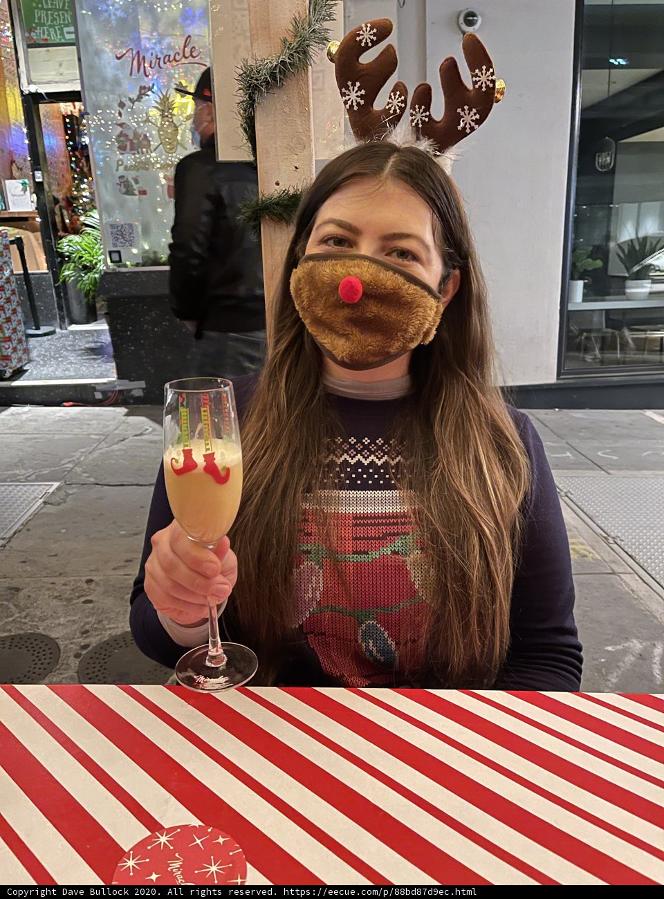 Reindeer-Horned Woman Enjoying a Festive Sundae
