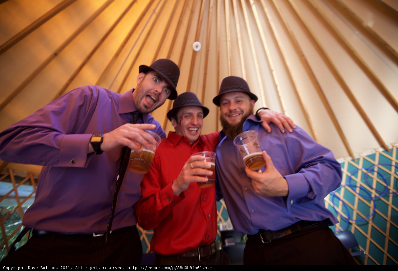 Three Men Cheers-ing Inside a Yurt at a Wedding
