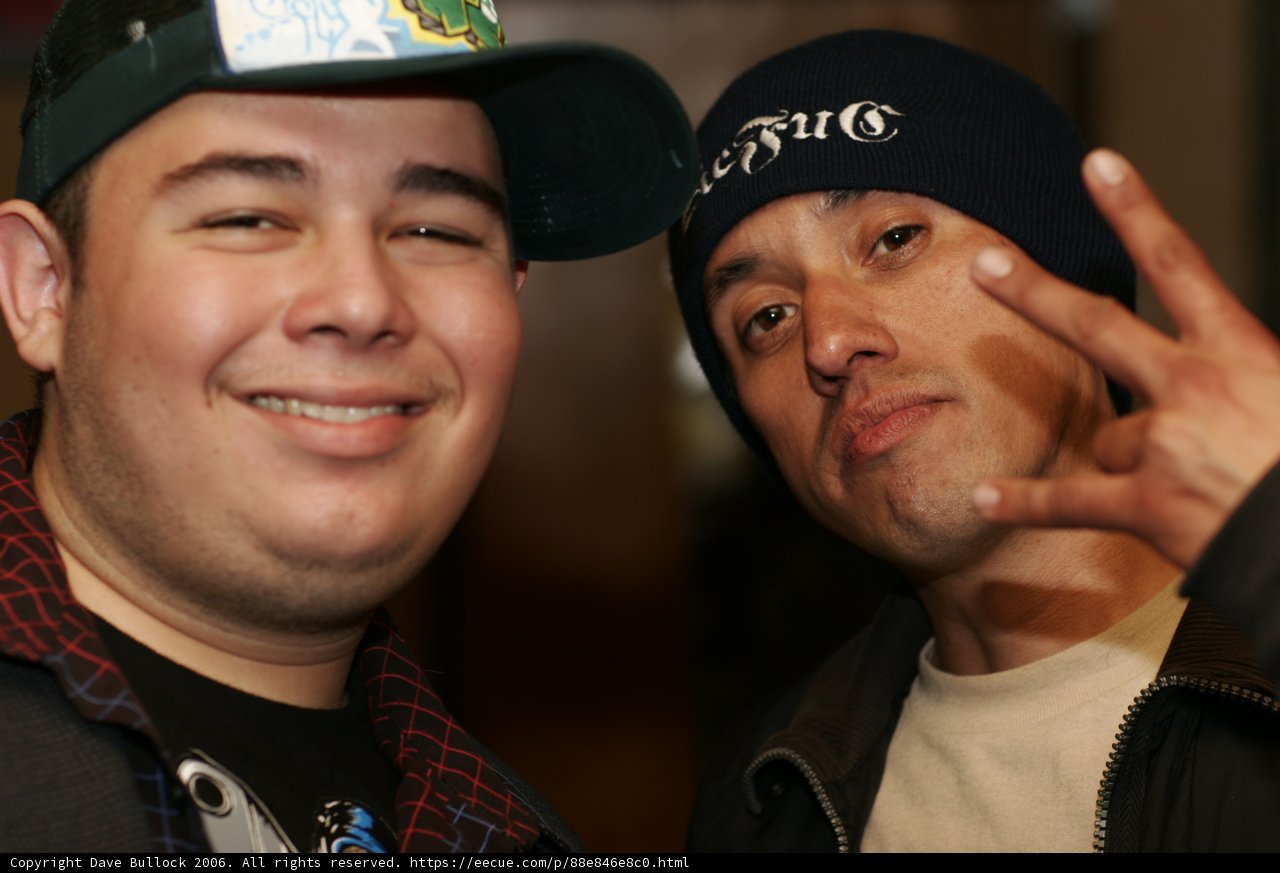 Two Men in Black Jackets and Baseball Caps