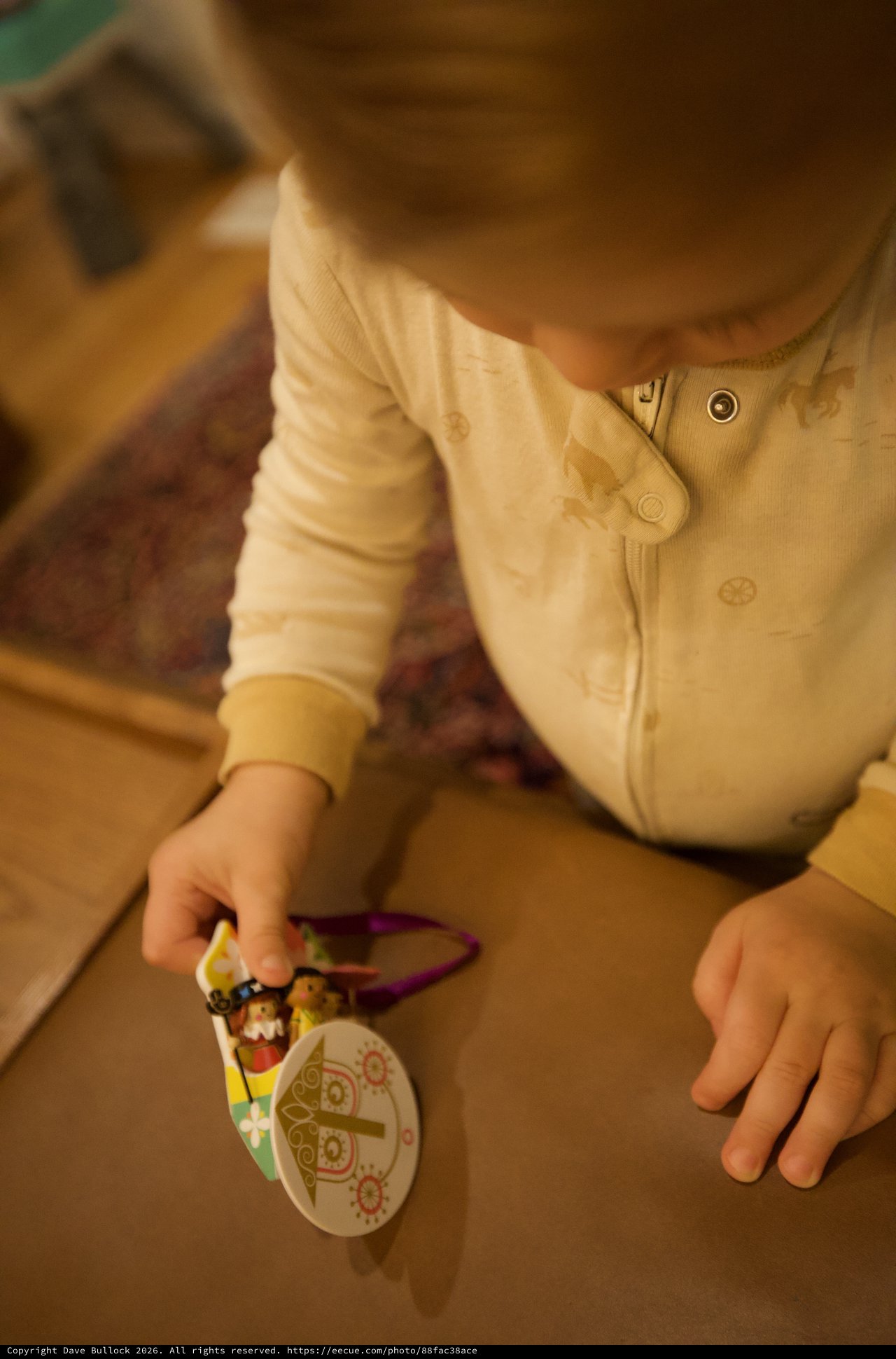 Young Child Playing with Christmas Ornament Toy