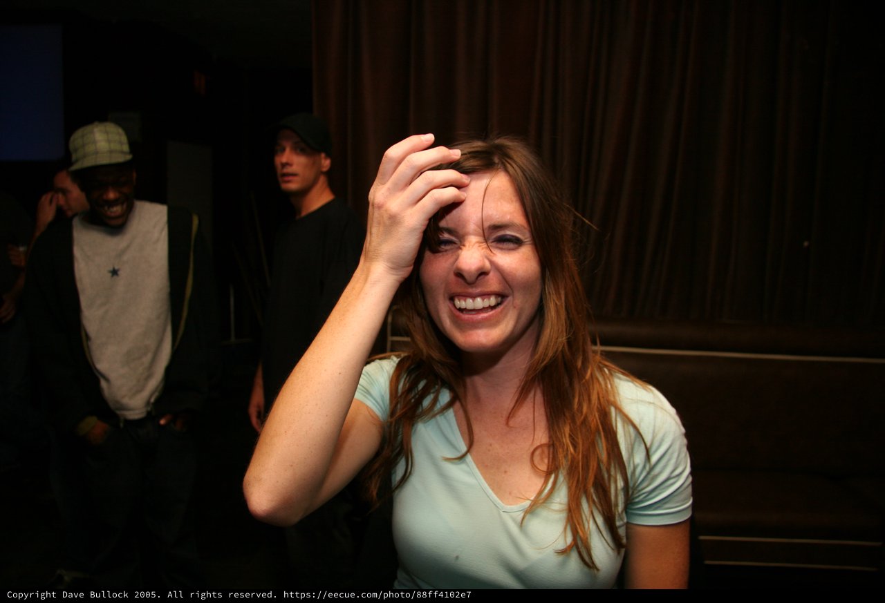 Woman Laughing Joyfully at Late Night Party