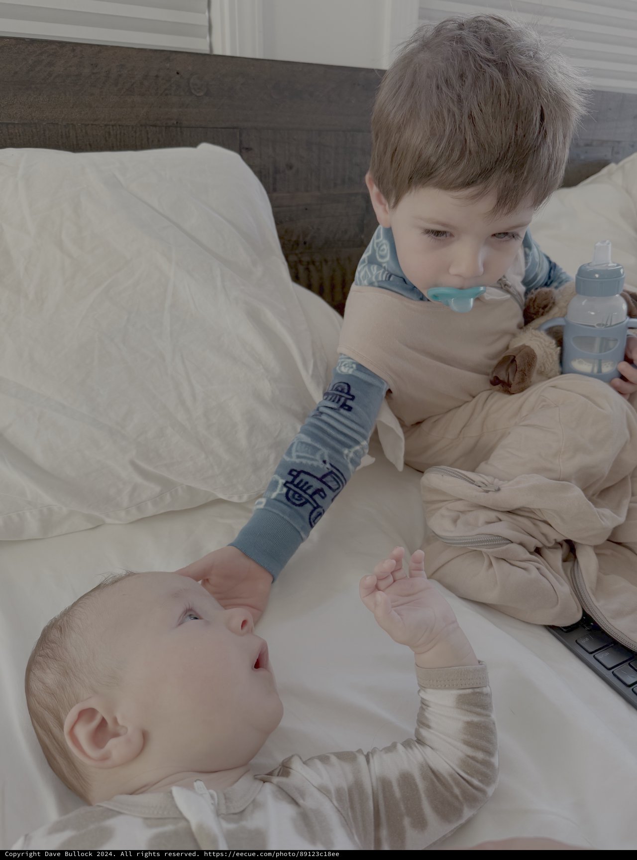 Big Brother Tenderly Watching Over Baby Sibling