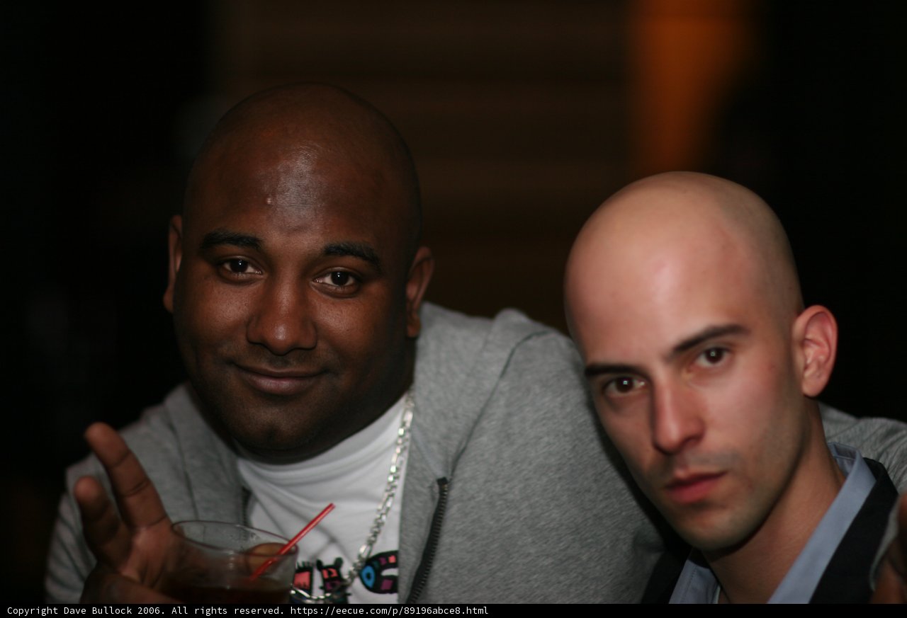 Two Men Enjoying Drinks at Club