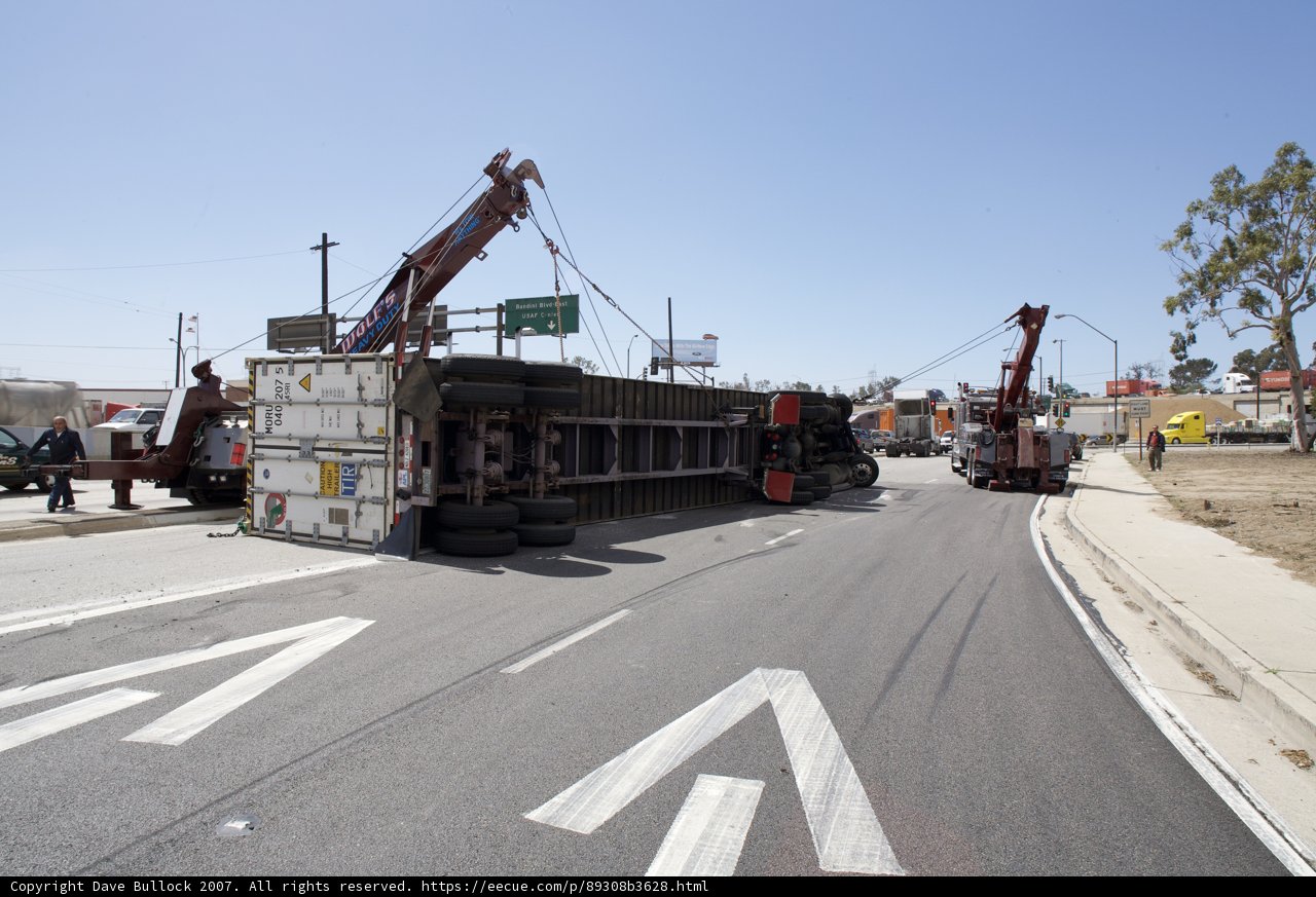 Overturned Truck Lifted by Construction Crane on Street