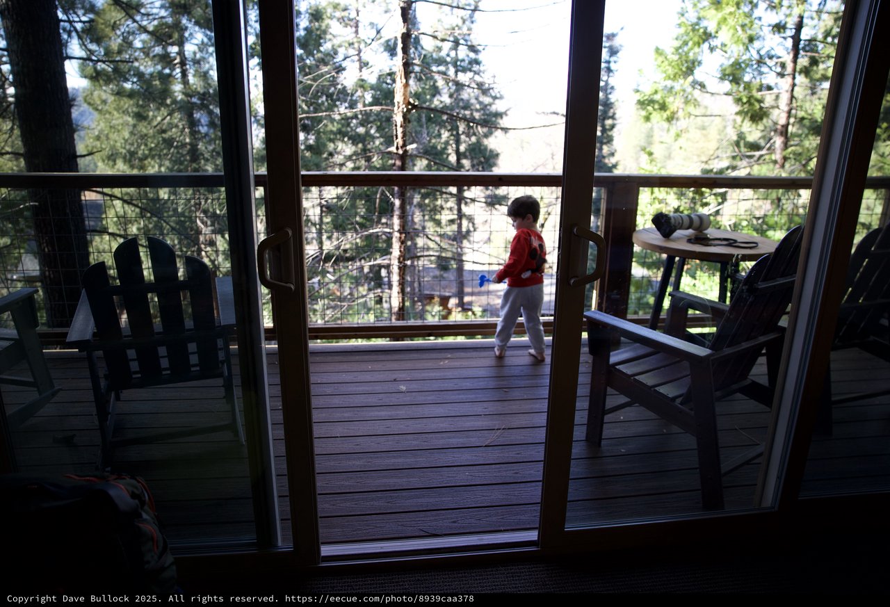 Child Playing on Mountain Cabin Deck at Dusk