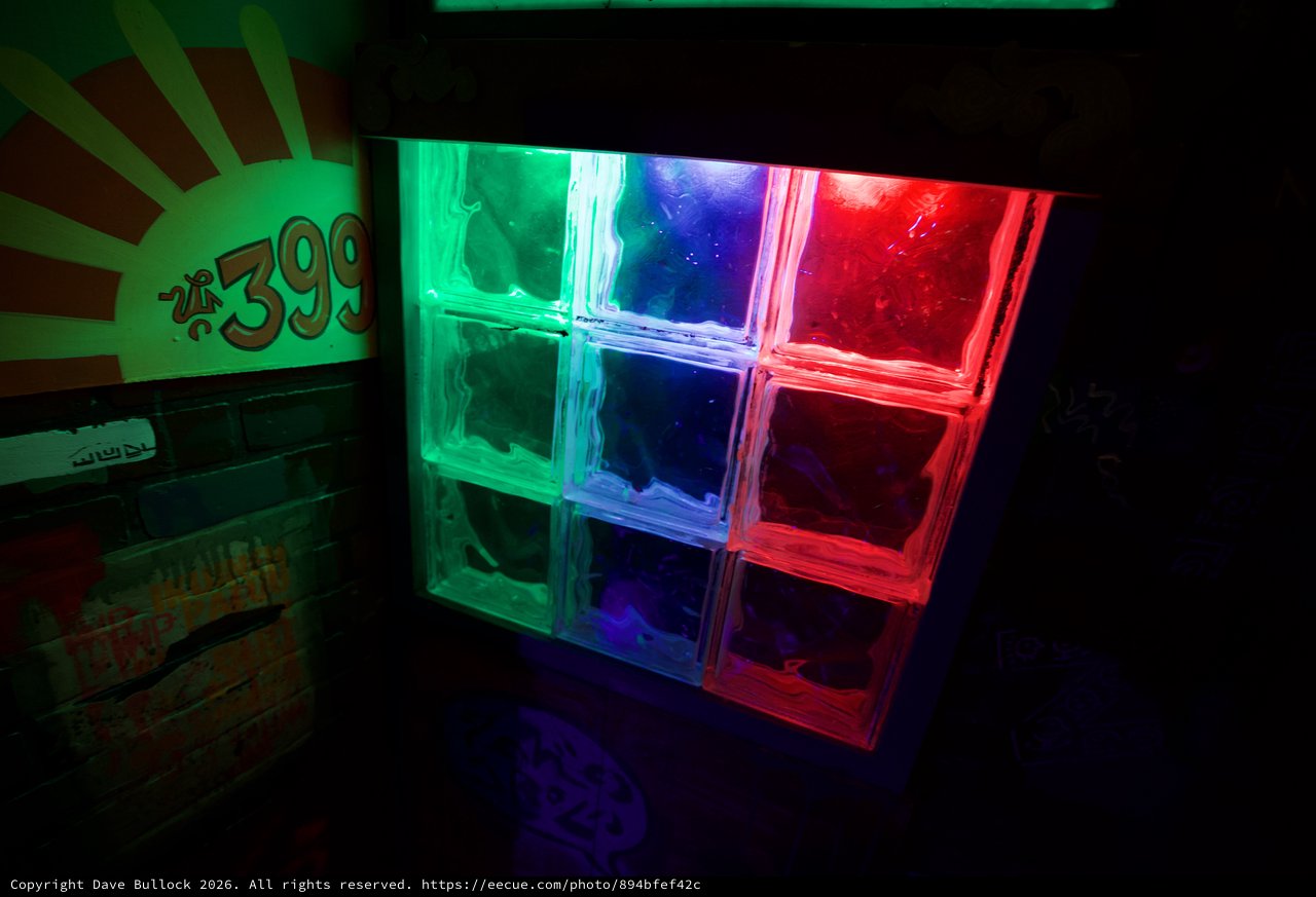 Illuminated Glass Block Wall with Retro Neon Design