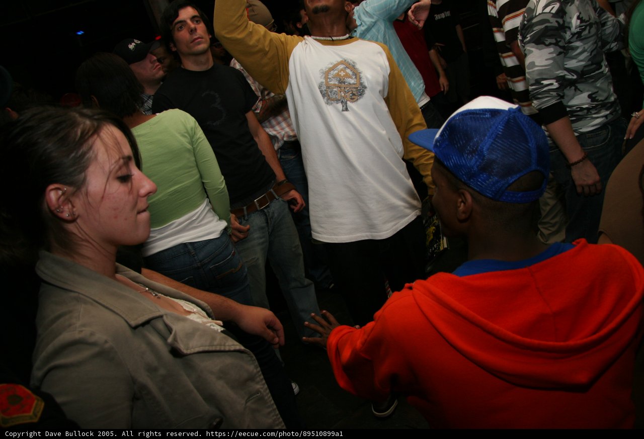 Man in White Shirt Blends into Urban Crowd