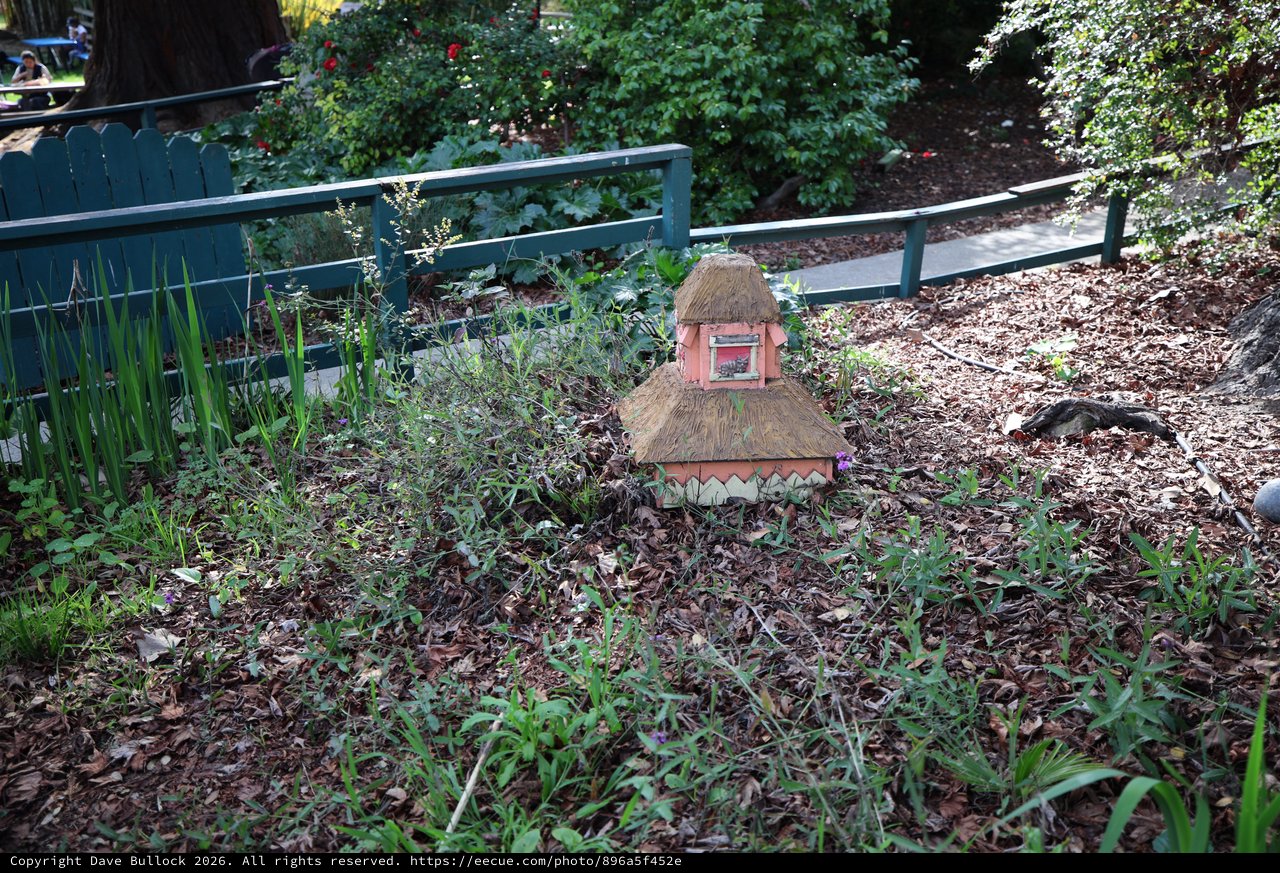 Whimsical Thatched Fairy House in Garden Setting