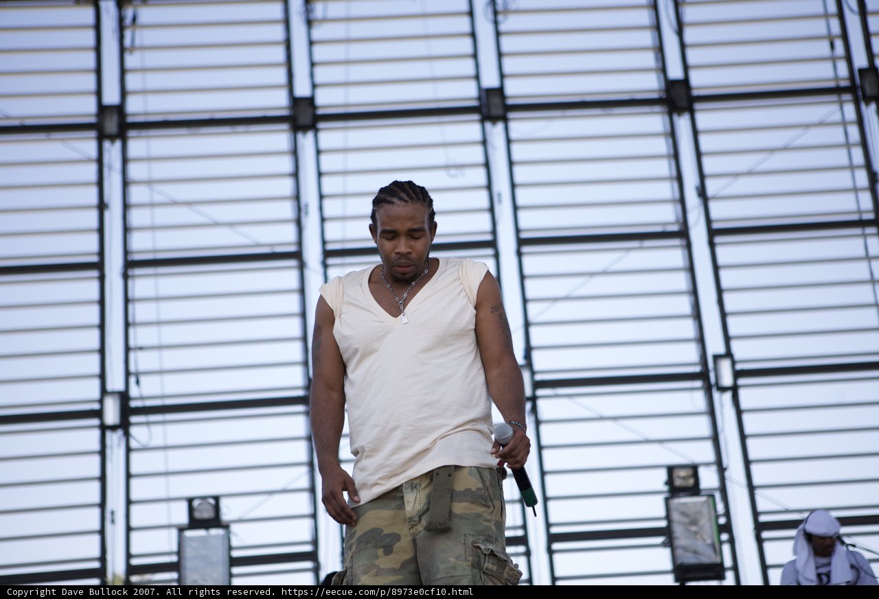 Pharoahe Monch Rocks the Stage in Camouflage and White Tank Top