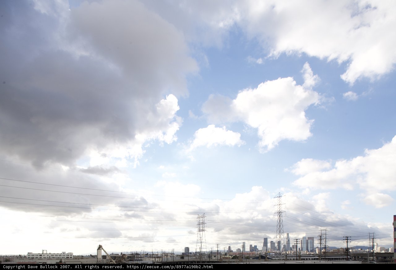 Cumulus Clouds over Industrial Landscape
