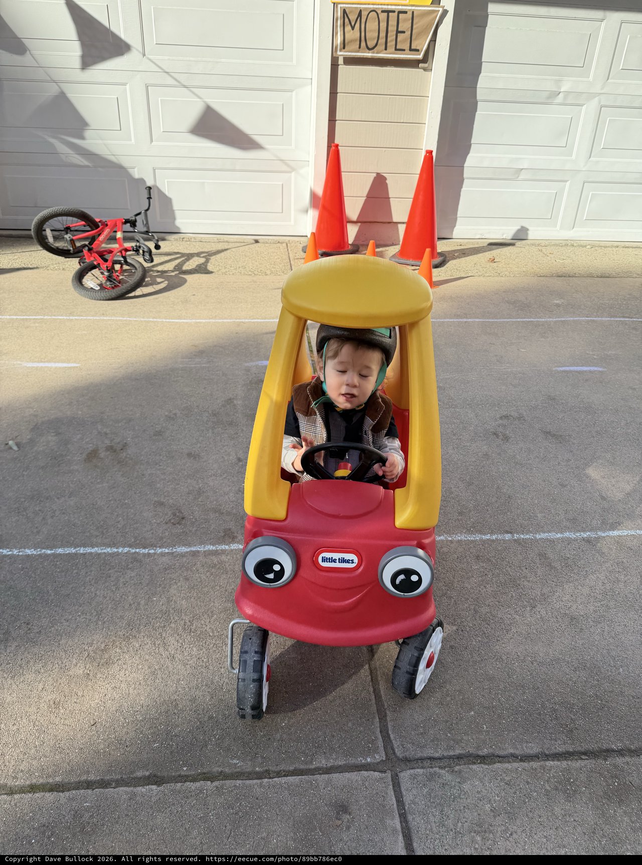 Toddler in Little Tikes Cozy Coupe with Traffic Cone Decoration