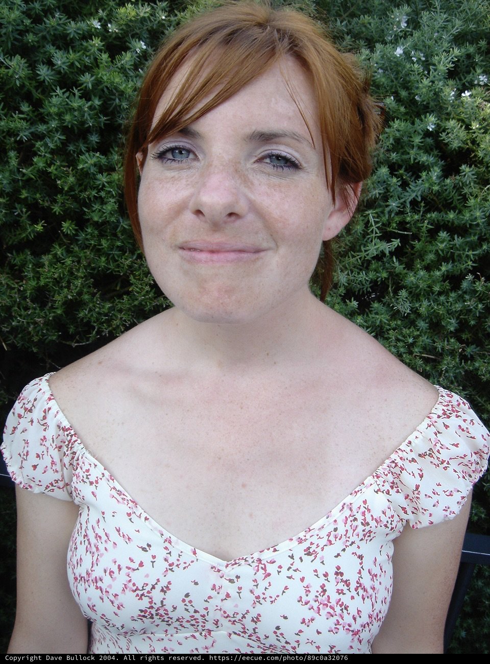 Freckled Redhead Woman Smiling Outdoors in Summer