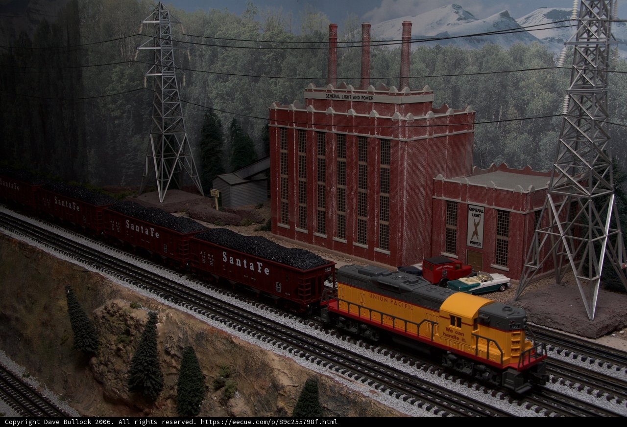 Toy Train on Railroad Track with Building