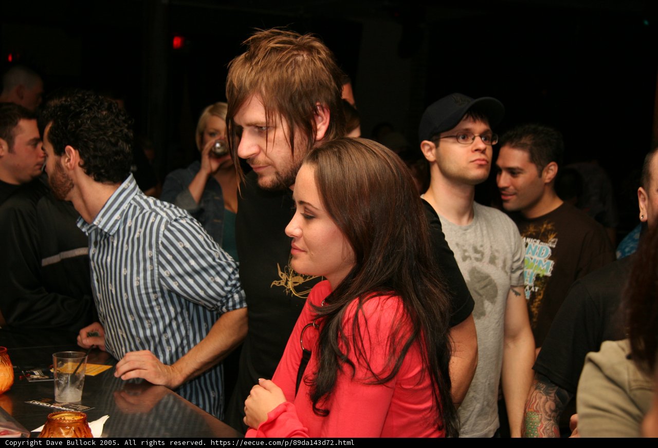 bearded man enjoys drinks at urban pub