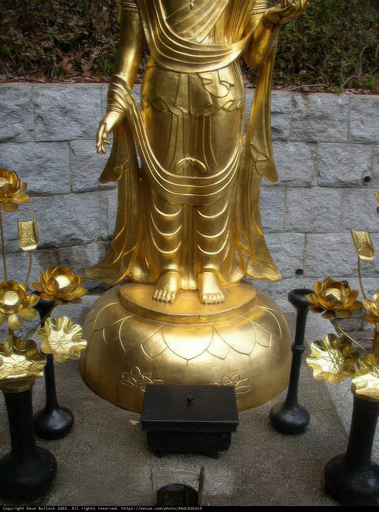 Golden Buddha Statue with Gold Flowers and Candles in Kyoto Temple