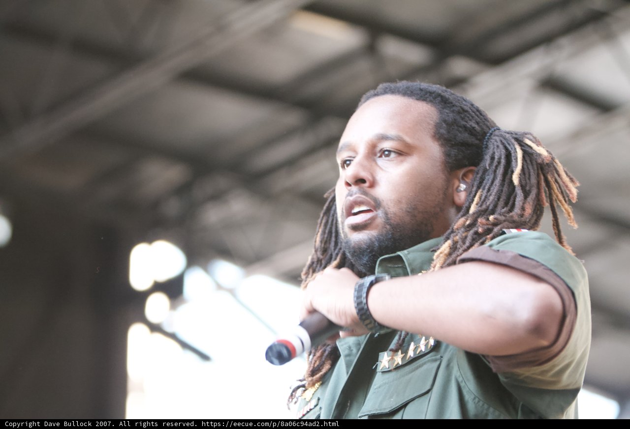Green-Shirted Dreadlock Performer Takes the Stage