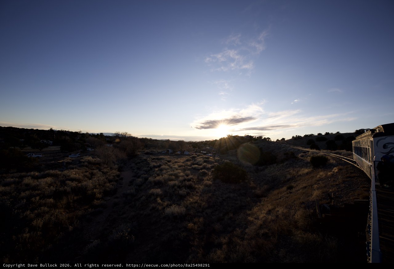 Sunset Over Desert Landscape with Train Car