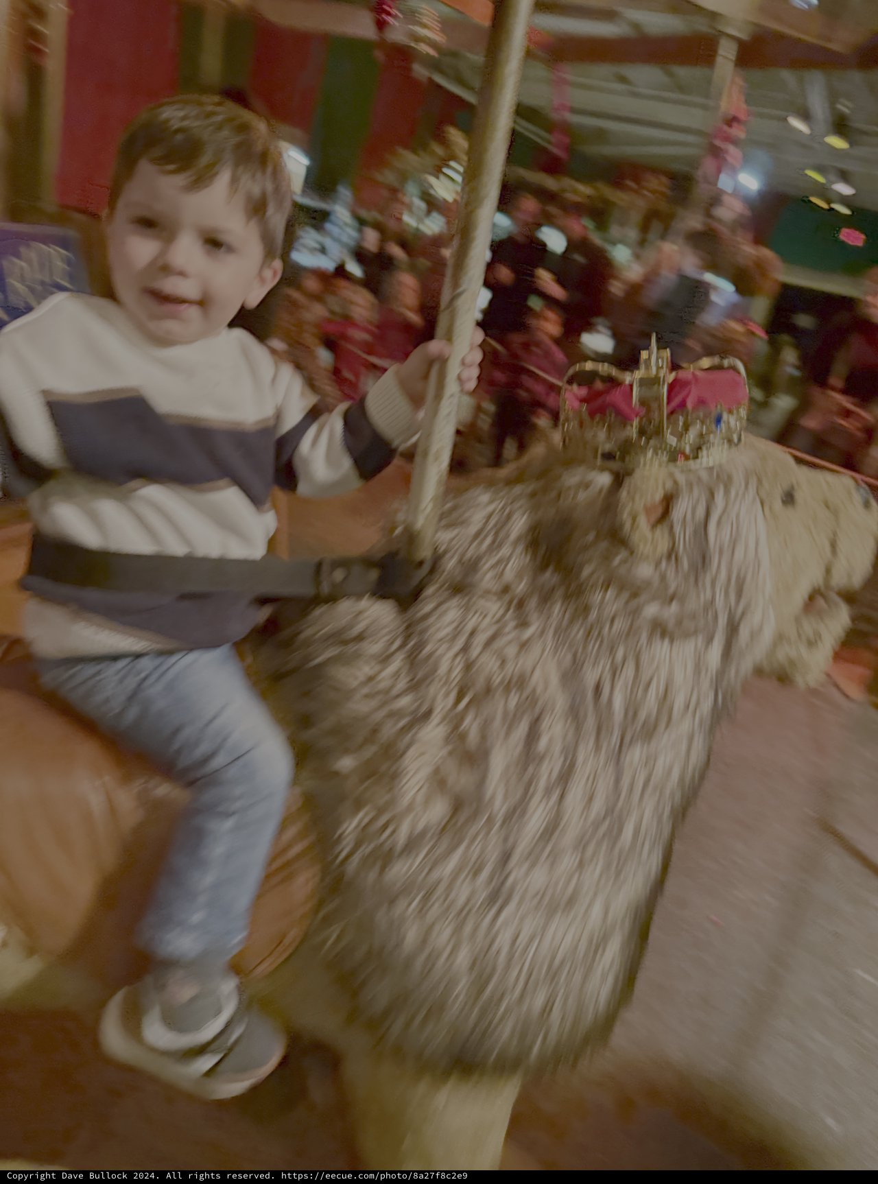 Child Enjoys Carousel Horse Ride at Fair