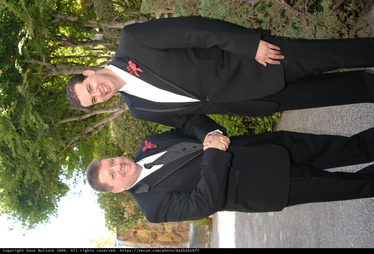 Two Groomsmen Share Handshake at Summer Wedding