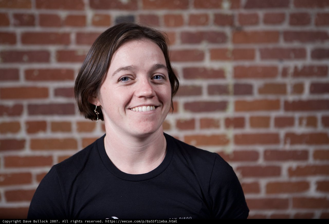 Smiling Woman Against Brick Wall