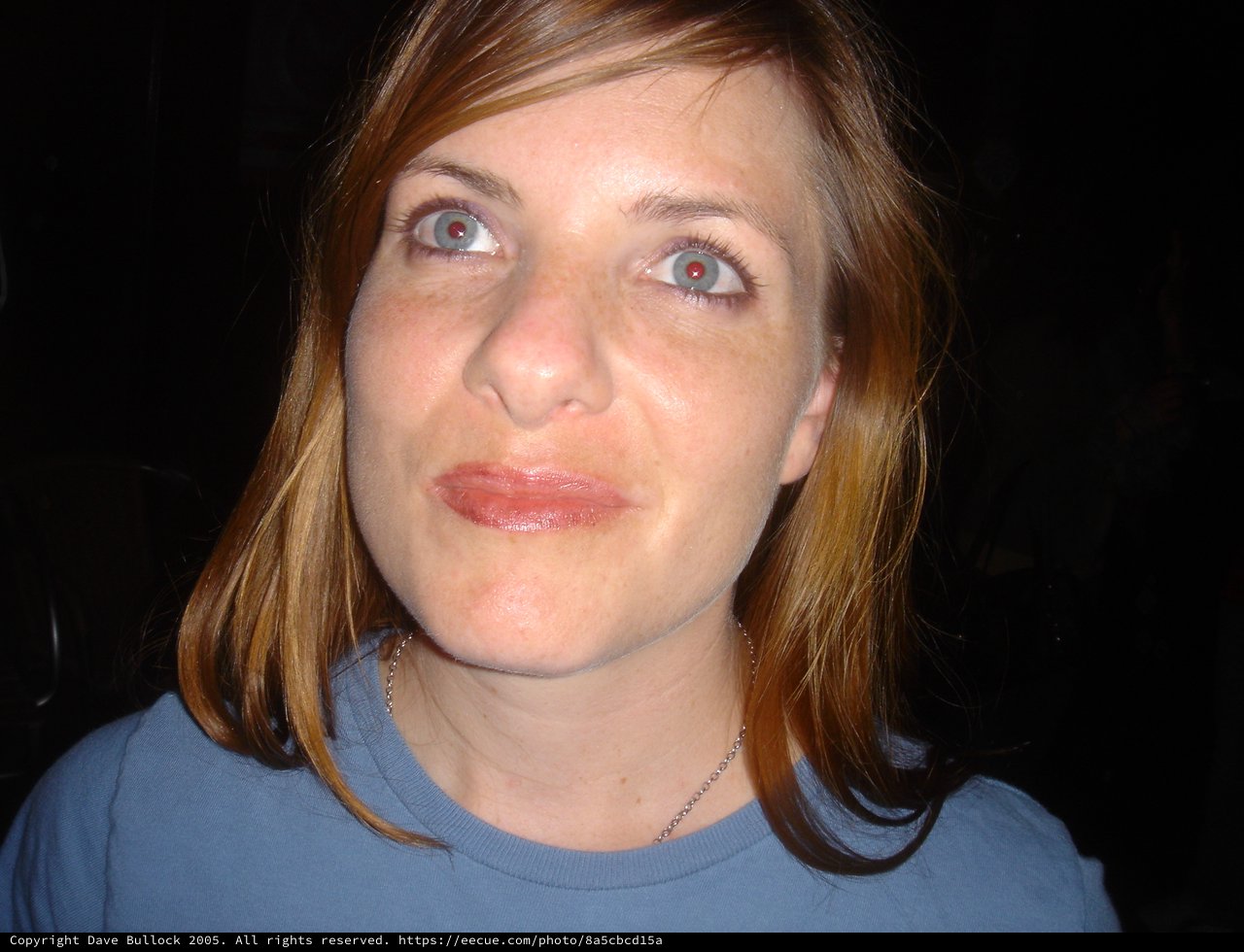 Woman with Red-Eye Effect Looks Upward Quizzically