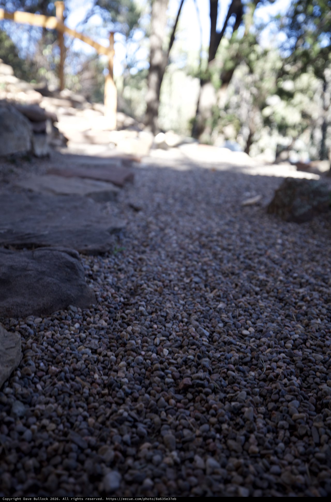 Low Angle View of Gravel Path Leading to Wooden Cross