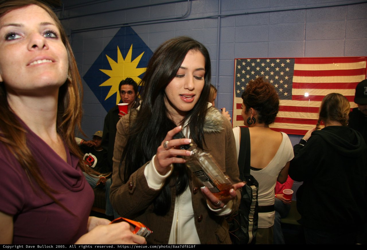 Two Women at an Indoor Party with Flags