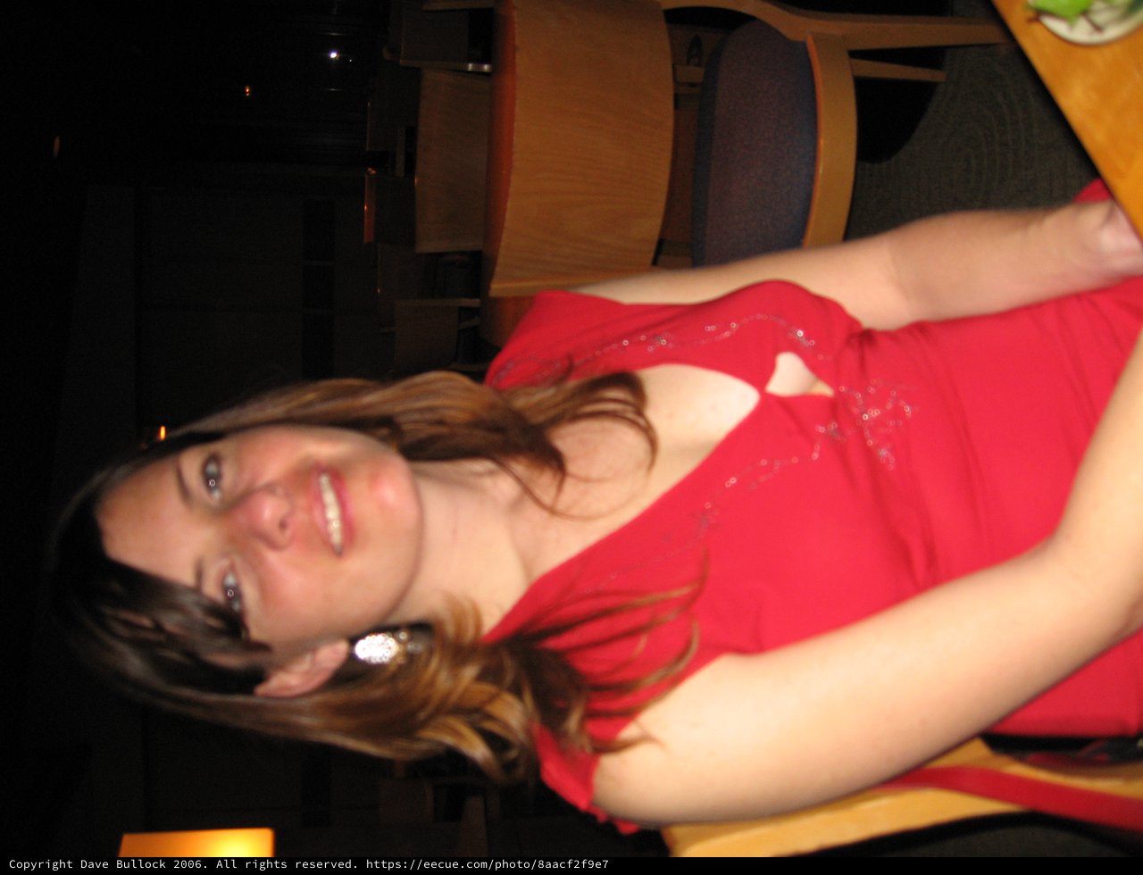 Woman in Red Dress Smiling at Restaurant Table