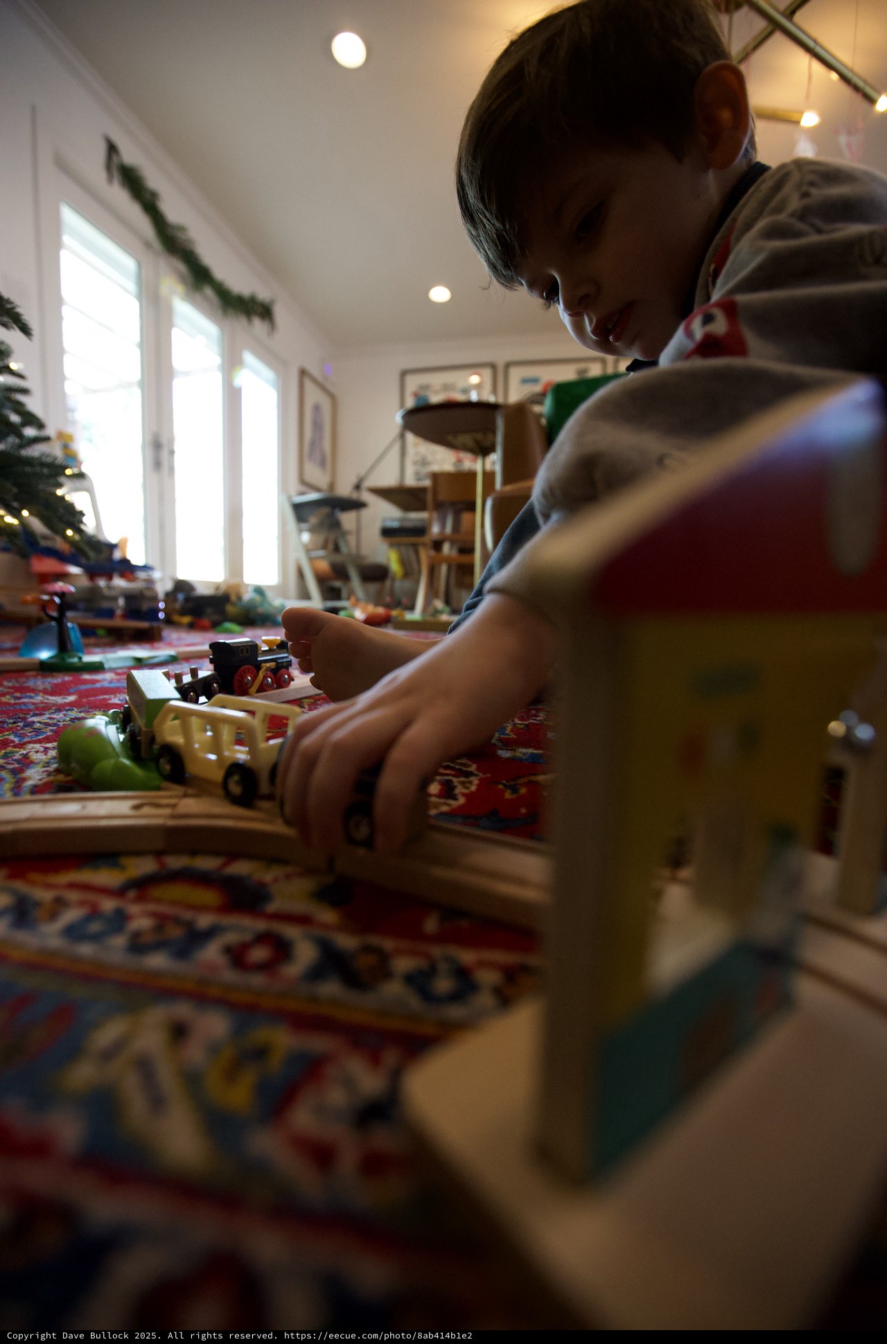 Child Playing with Toy Trains on Christmas Morning