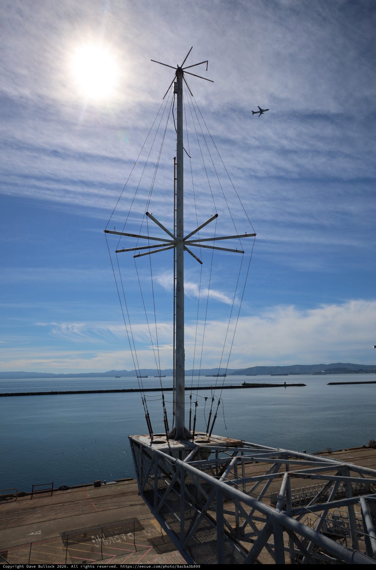 Antenna Mast Silhouette Against Bay Waters and Sky