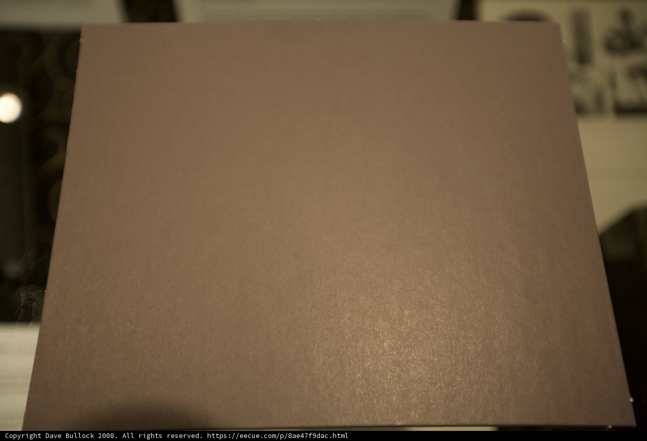 Texture of a Brown Paper Sheet on a Wooden Table