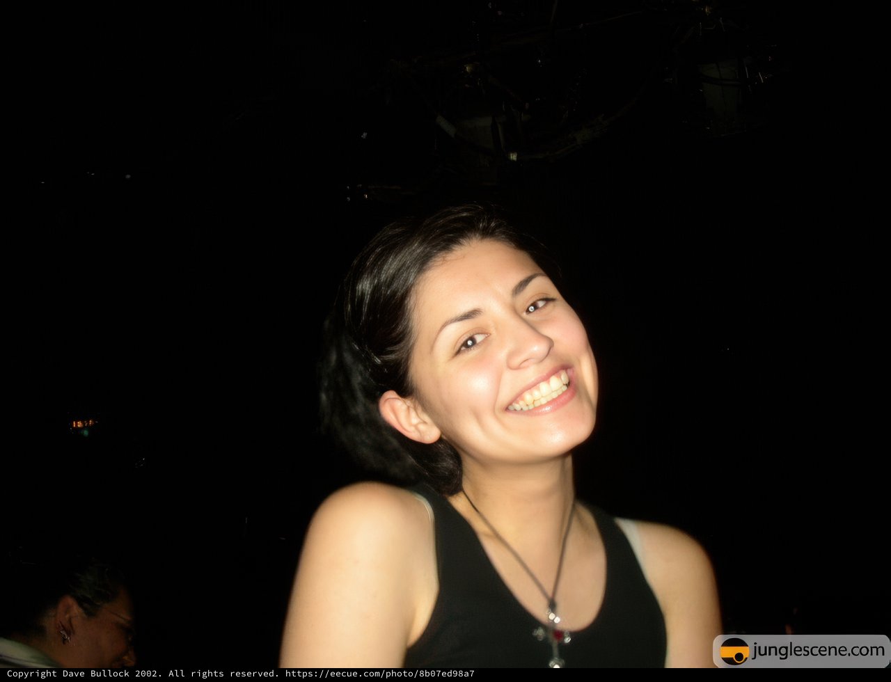 Smiling Woman with Urban Nightlife Background