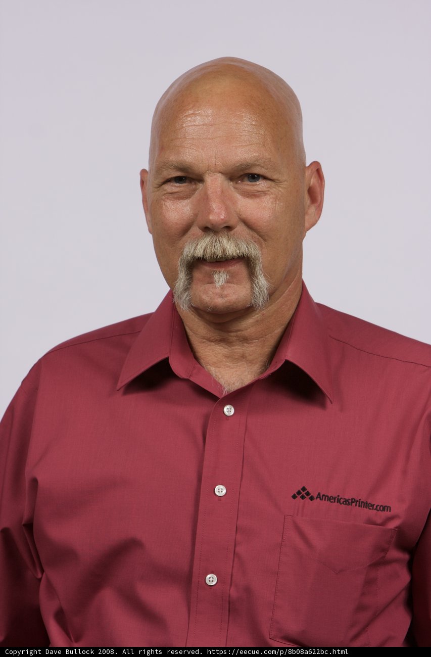 The Red Shirted Bald Man with a Mustache