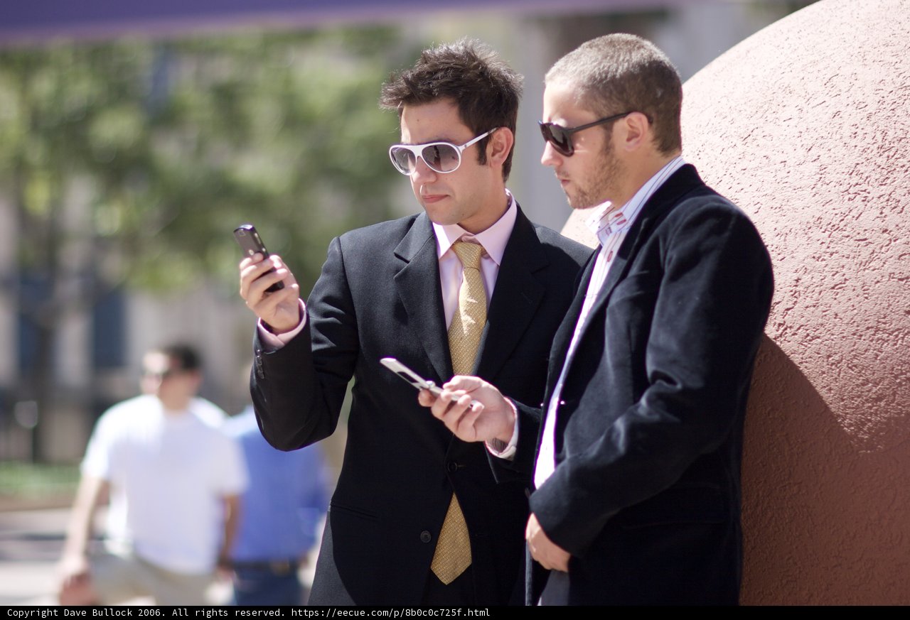Businessmen checking their phones