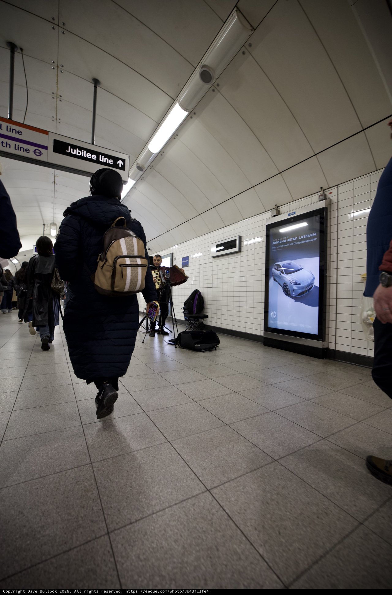 Commuter Walking Through London Underground Station Corridor