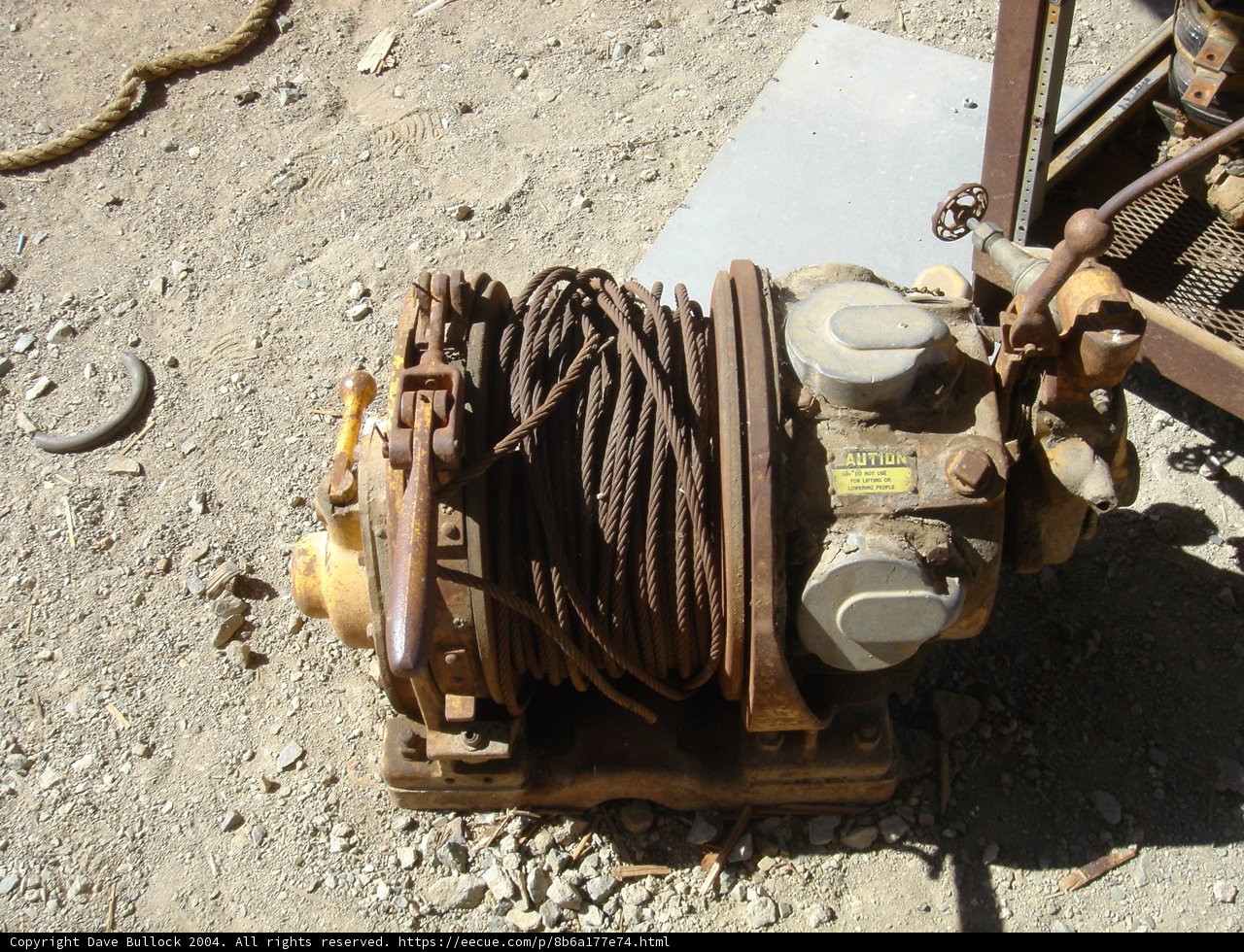 Rusty Hand Pump Abandoned on the Ground