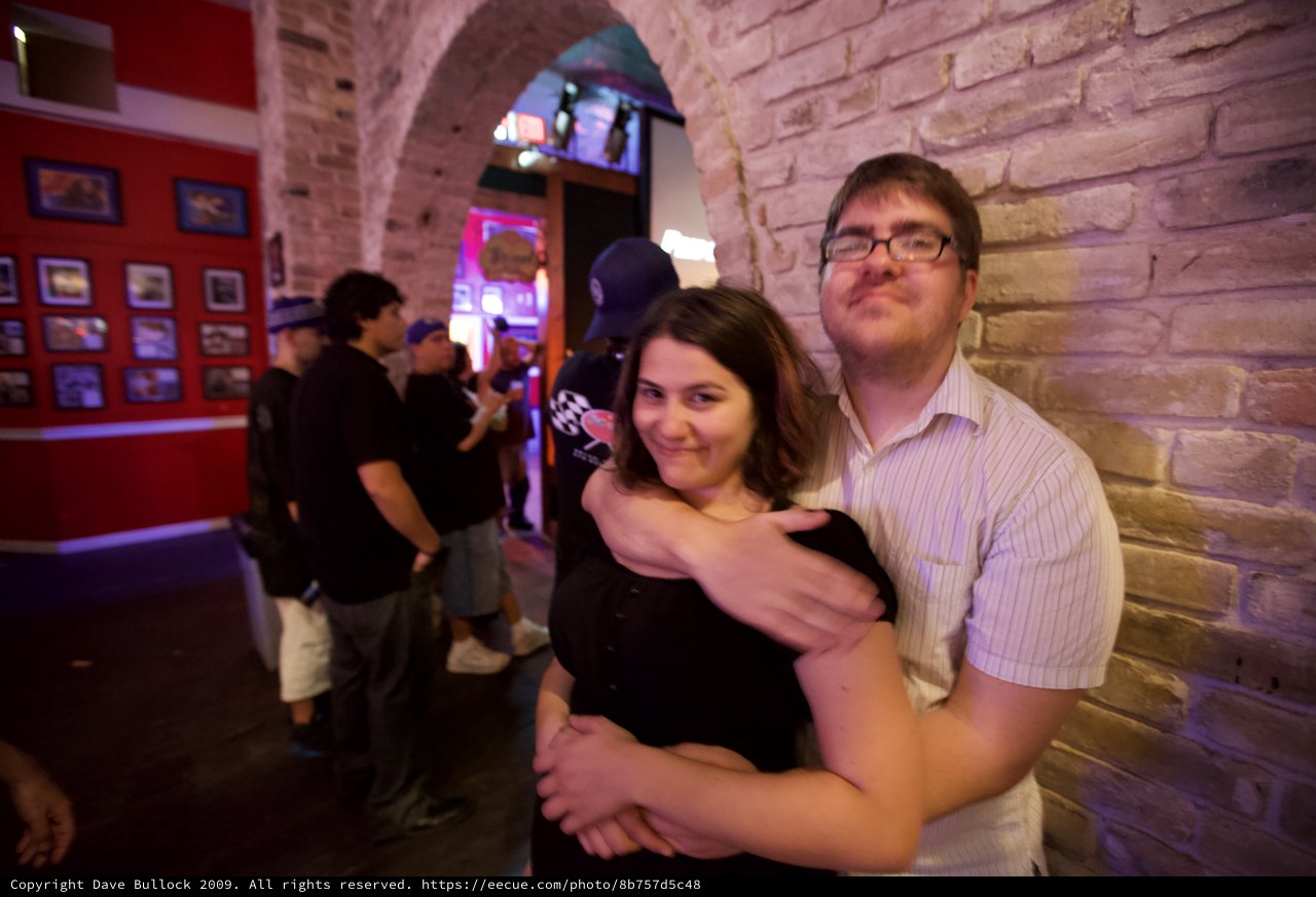 Couple Embracing at Austin Bar Under Stone Arch