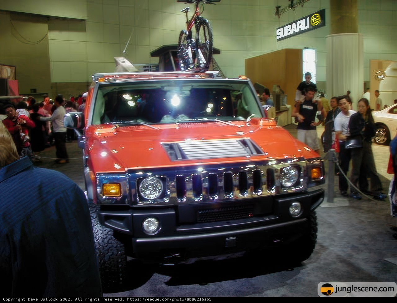 Red Hummer Truck with Bicycle on Top