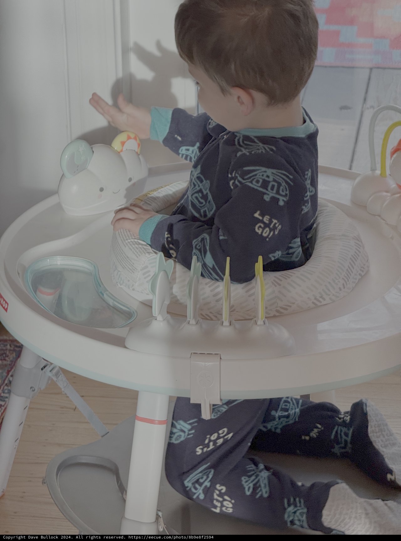 Toddler Playing in High Chair Activity Center