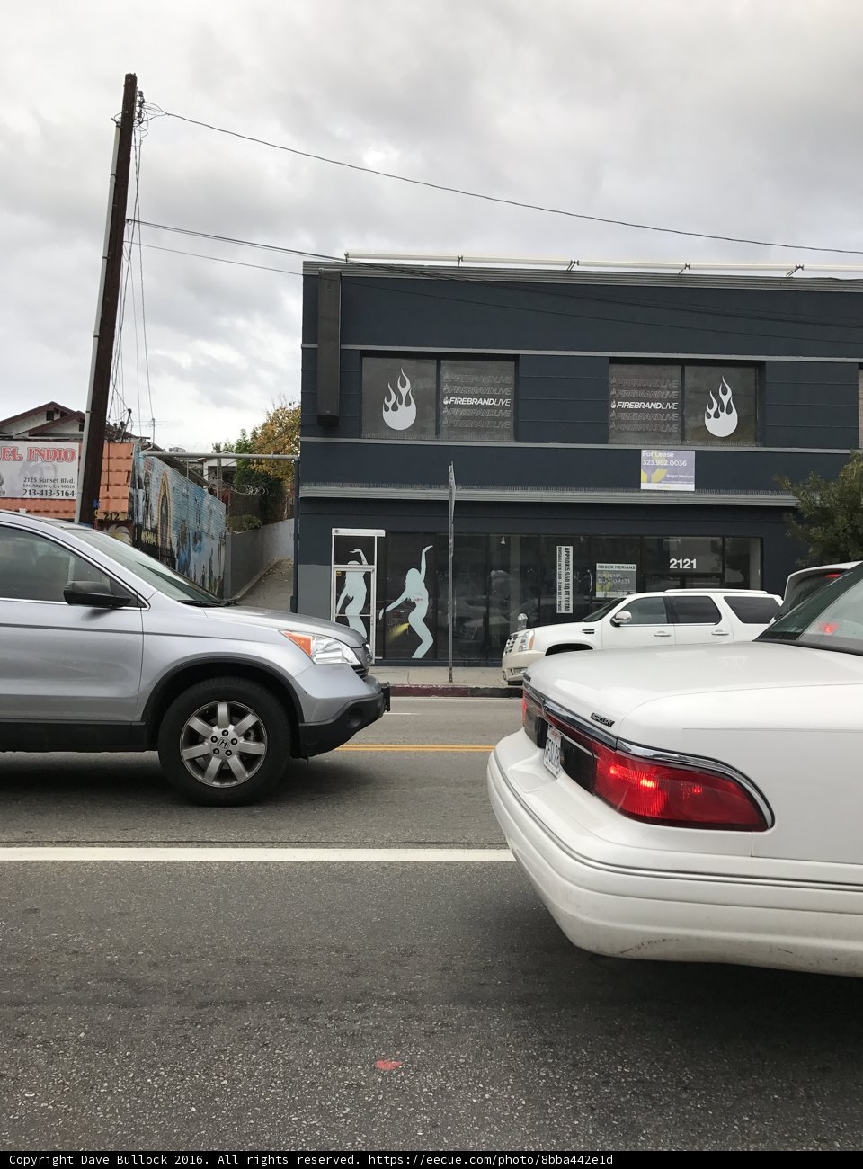 White Sports Car Parked Outside Building