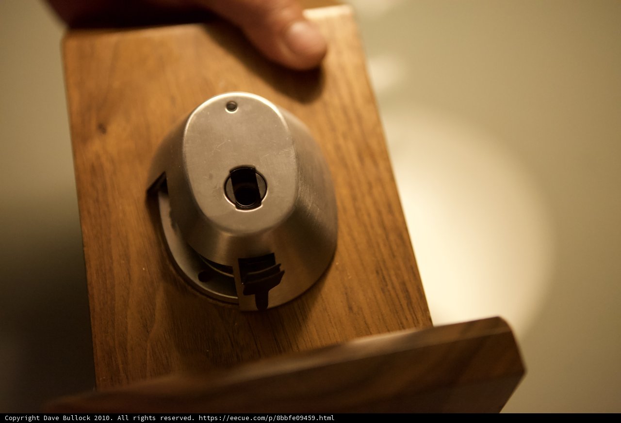 Holding Metal Object on Wooden Surface