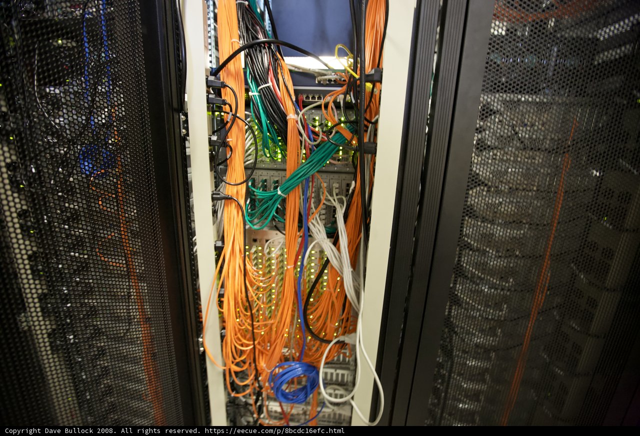 Robotic Servers in Chaos Caption: The intricate wiring and hardware of these robotic servers create a bustling web of technology.