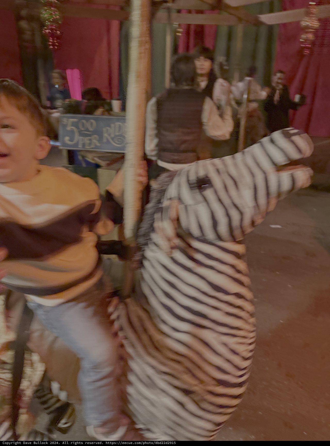 Child Playing on Motion-Blurred Carousel Ride
