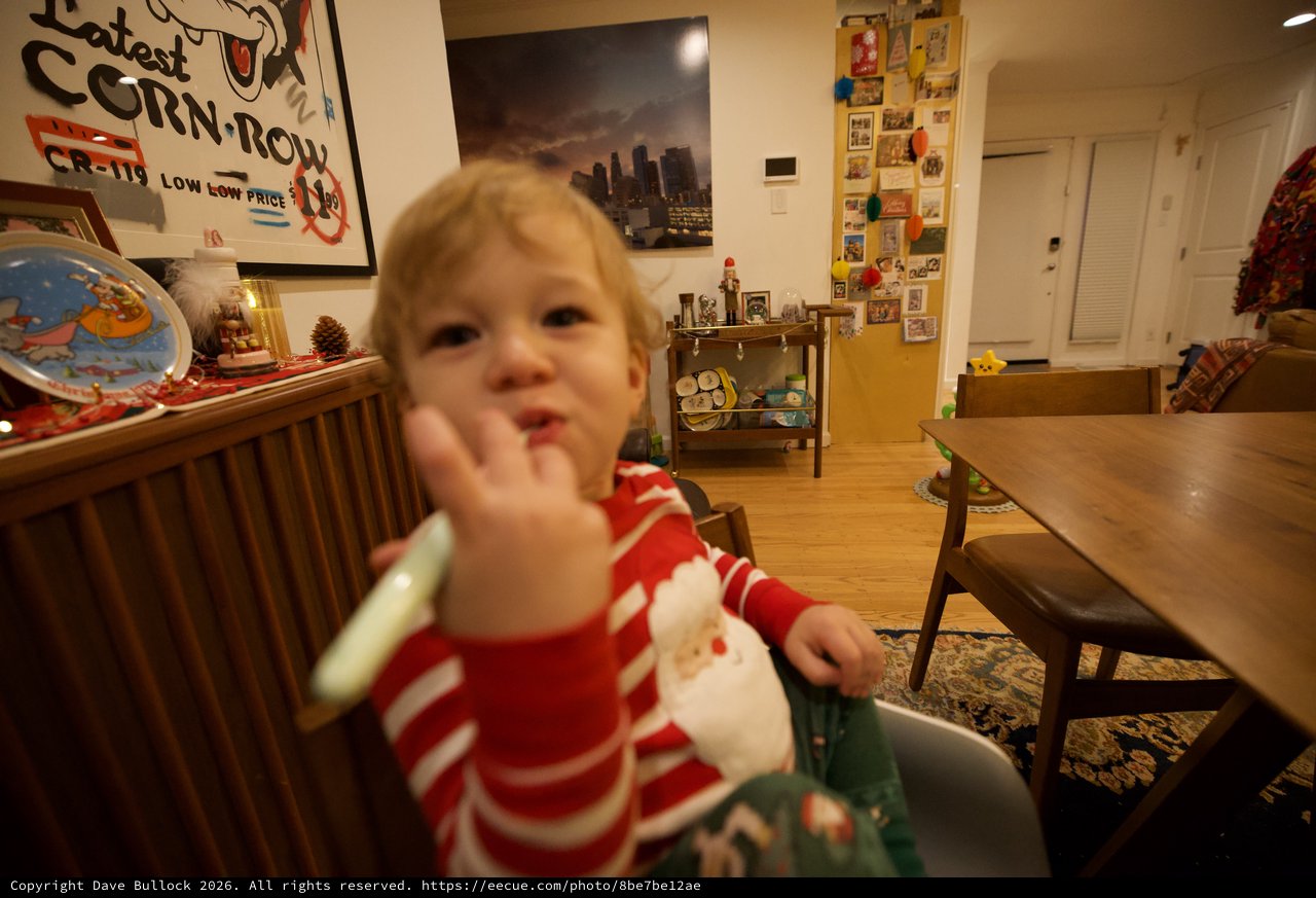Toddler in Red Striped Pajamas Waving at Camera