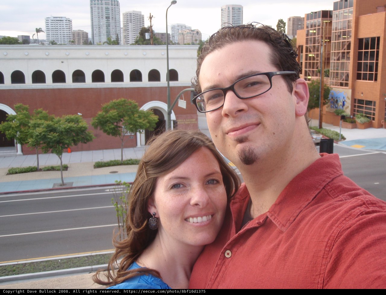 Couple Selfie on Urban Rooftop Overlooking City Street