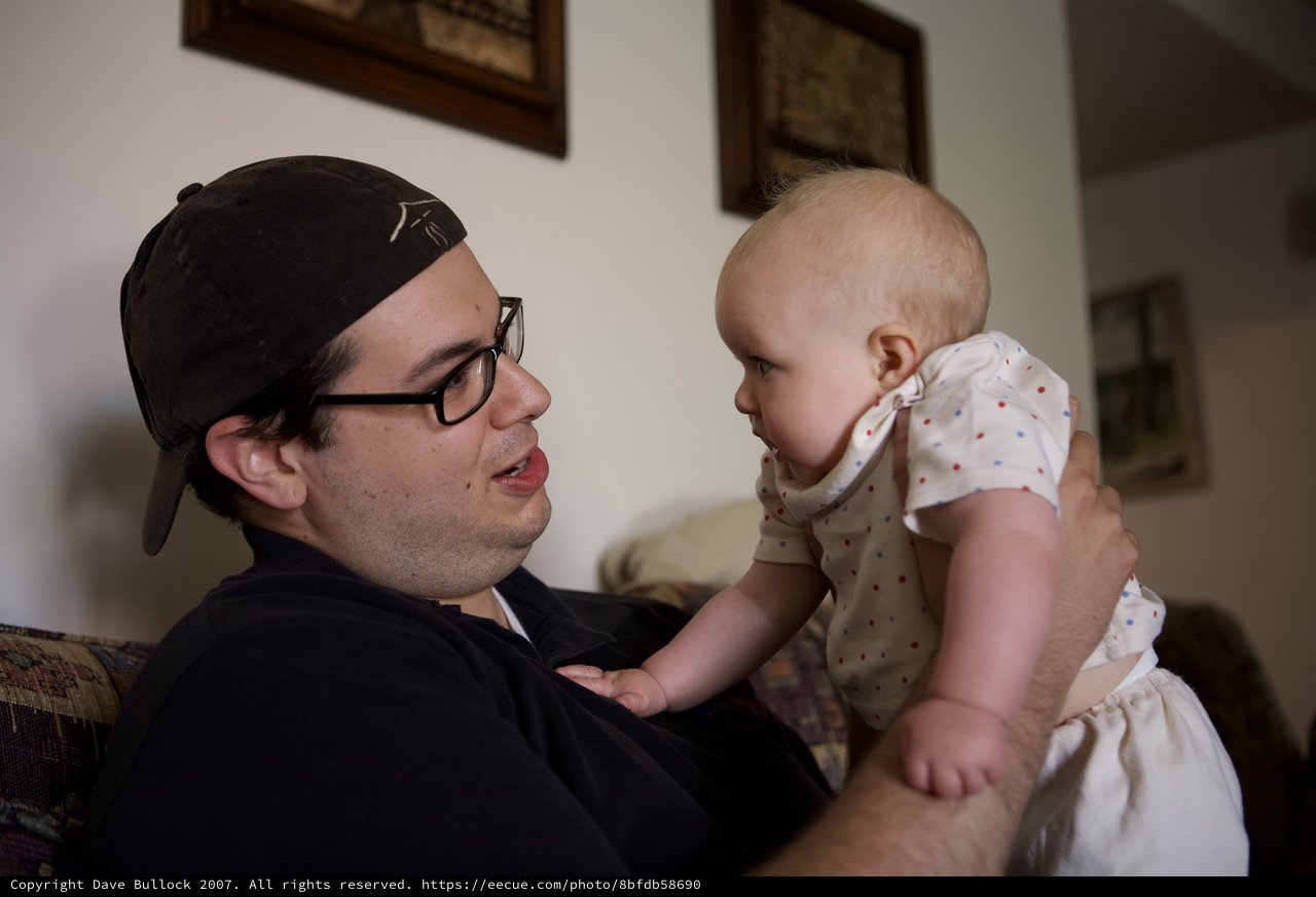 Young Man Bonding with Baby Indoors at Home