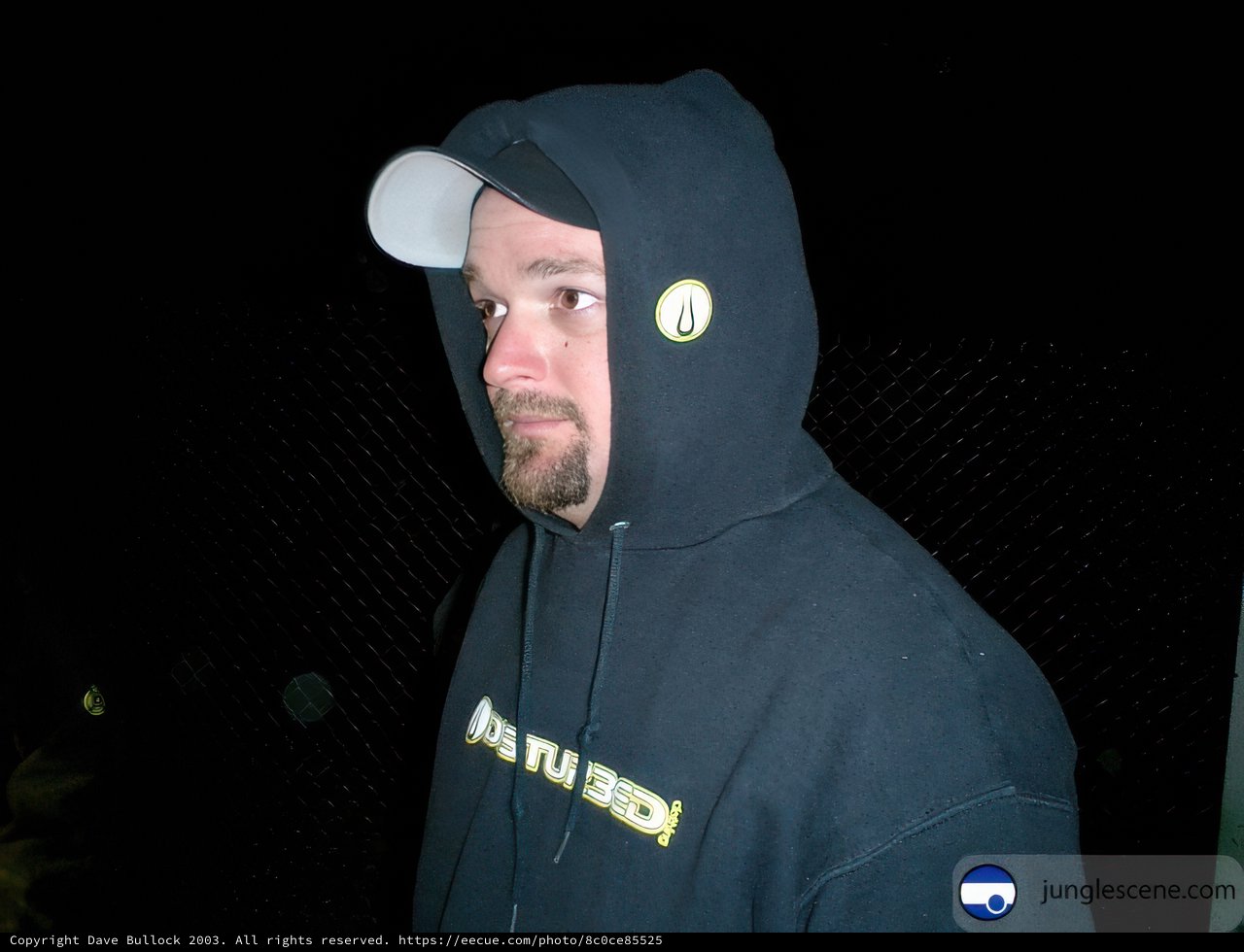 Man in black hoodie and white hat