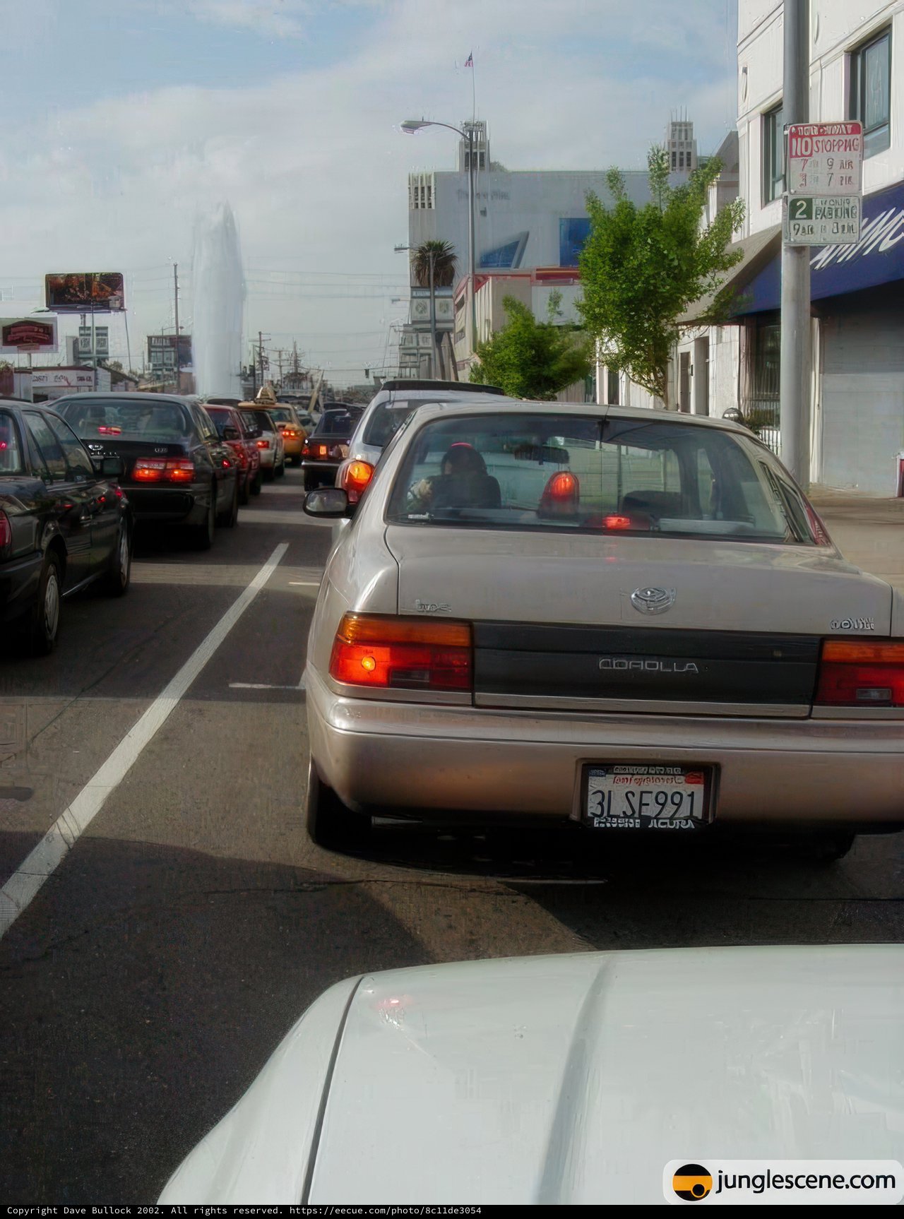 White Sedan Stuck in Traffic