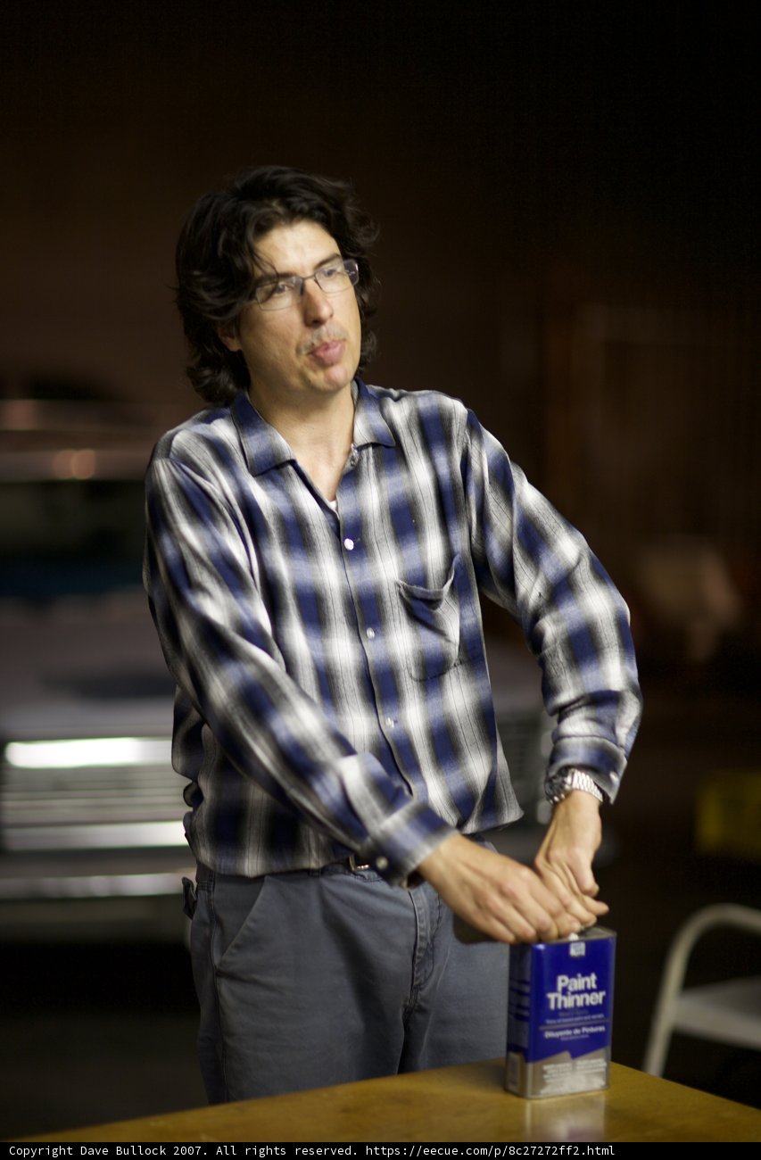 Man in Plaid Shirt with Bottle and Glasses