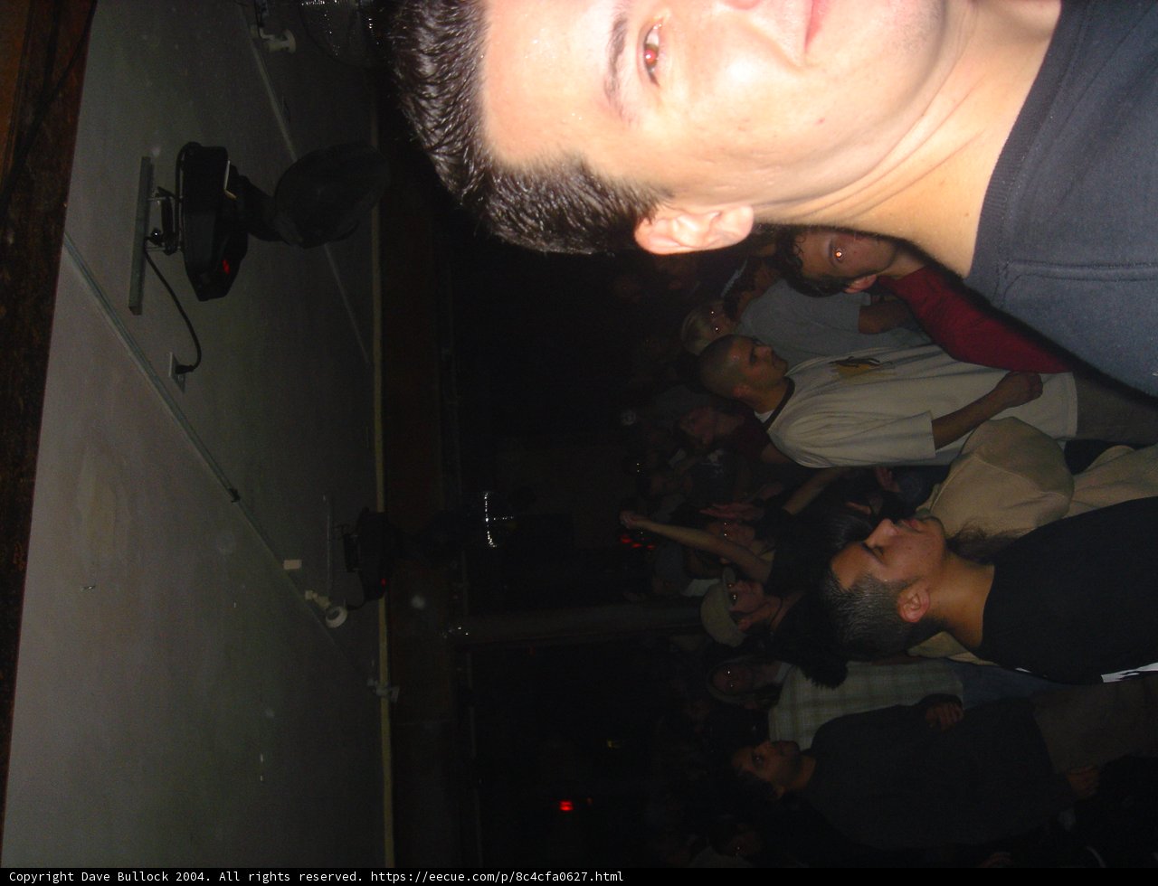 Man Commands Attention from Crowd at Nightclub